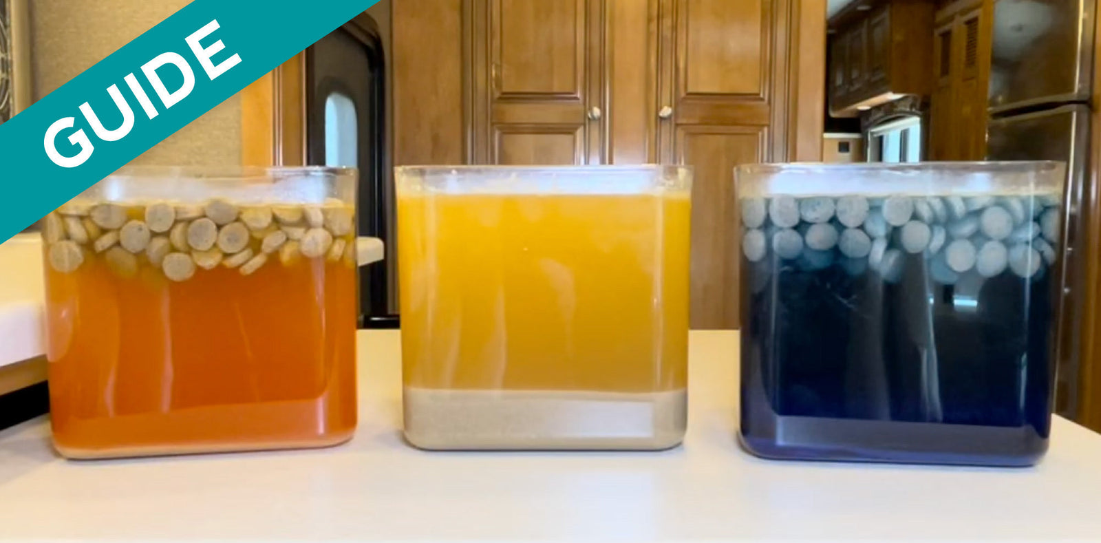 Three Clear Containers on a RV Kitchen Counter With Three Different Holding Tank Treatments Being Demonstrated using Dog Food
