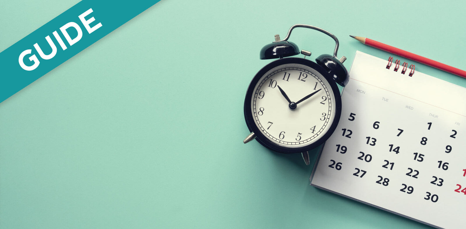 Alarm clock and calendar near a pencil, illustrating timing for RV holding tank maintenance.