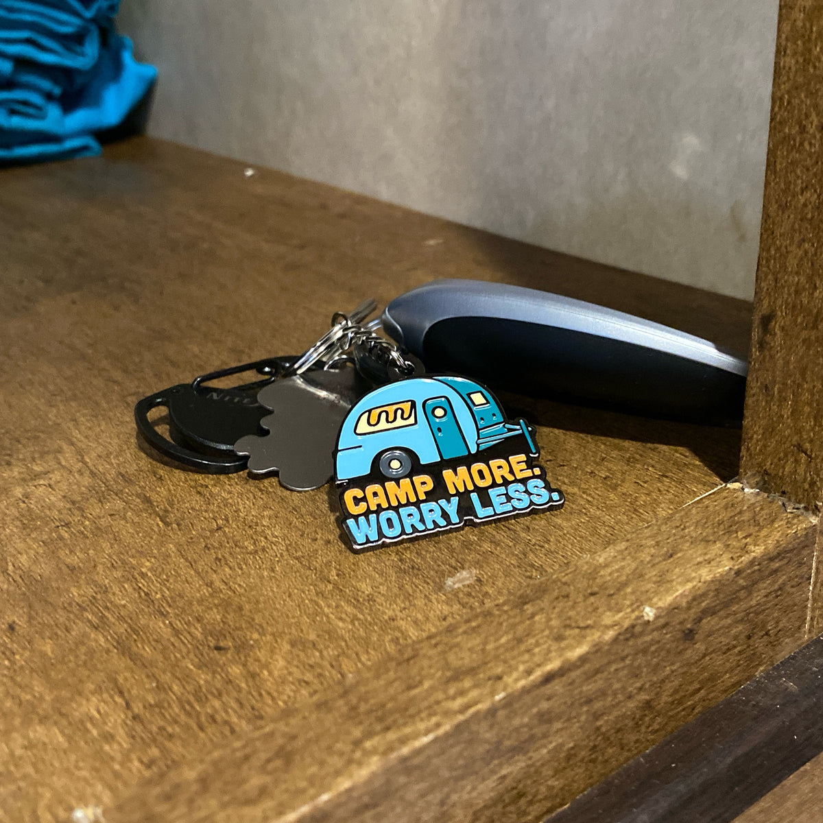 Camp More. Worry Less. Keychain on keys inside RV cabinet. Unique Camping + Marine
